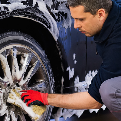 A Detail Washing Wheels and Tires on a Car in Wausau Wisconsin